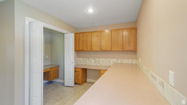 401 N Fairgrounds Rd, Price, UT 84501 - kitchen with light tile patterned floors, decorative backsplash, and built in desk