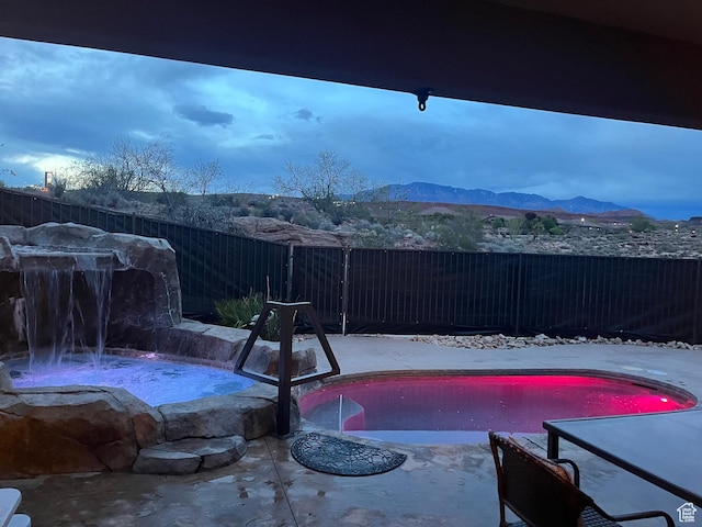650 N Red Stone Rd Unit 22, Washington, UT 84780 - view of pool with a jacuzzi, a fenced in pool, a mountain view, and a fenced backyard
