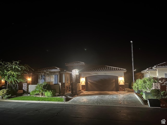 650 N Red Stone Rd Unit 22, Washington, UT 84780 - view of front of house featuring driveway, stucco siding, a tile roof, and a garage