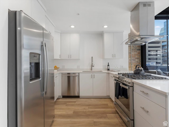 231 S Edison St E Unit 7, Salt Lake City, UT 84111 - kitchen with stainless steel appliances, island range hood, light countertops, light wood-style floors, and recessed lighting