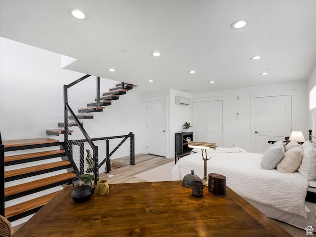 231 S Edison St E Unit 7, Salt Lake City, UT 84111 - bedroom with recessed lighting, light wood-style flooring, and a wall unit AC