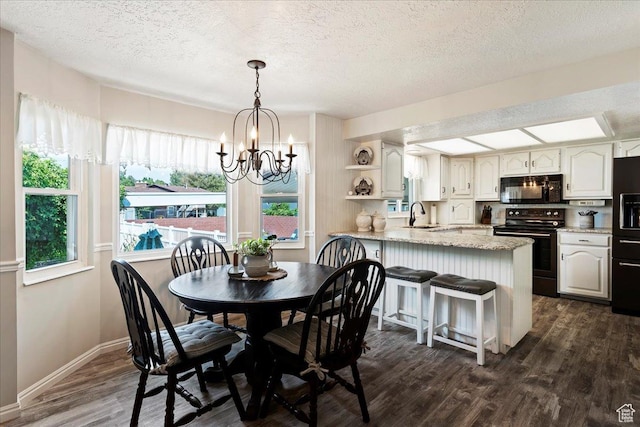 1154 W 1700 S, Syracuse, UT 84075 - dining area with a textured ceiling, dark wood-style flooring, a notable chandelier, and baseboards
