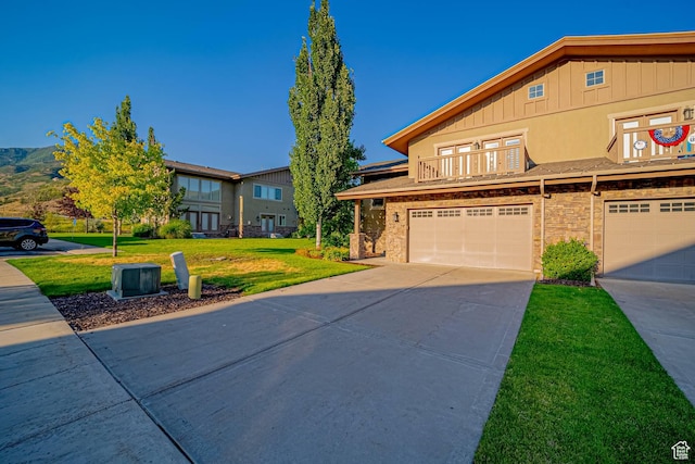 1120 N 520 W Unit 1, Midway, UT 84049 - multi unit property with concrete driveway, an attached garage, board and batten siding, a front yard, and a balcony