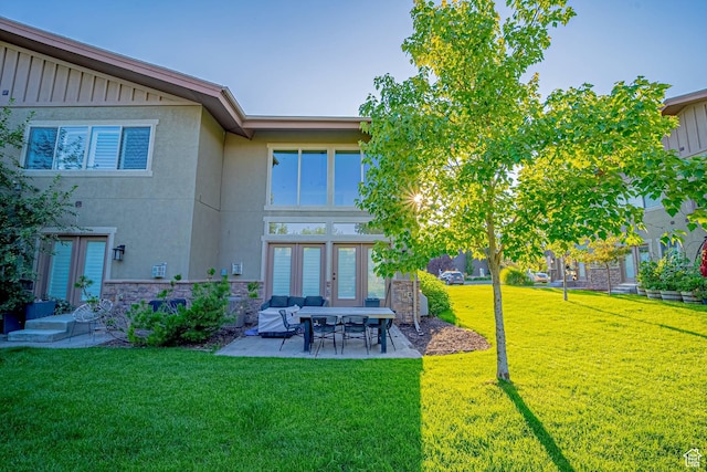 1120 N 520 W Unit 1, Midway, UT 84049 - rear view of property featuring stone siding, french doors, a lawn, stucco siding, and board and batten siding