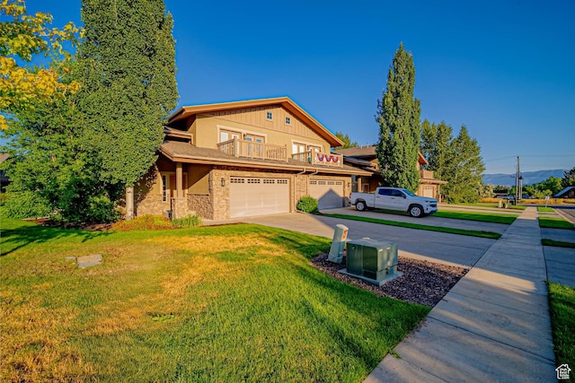 1120 N 520 W Unit 1, Midway, UT 84049 - view of front facade with driveway, a balcony, stone siding, and a front lawn