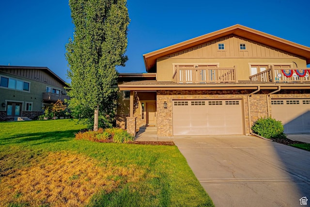 1120 N 520 W Unit 1, Midway, UT 84049 - view of front of property with an attached garage, a balcony, concrete driveway, stone siding, and a front yard