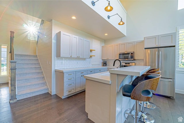 1120 N 520 W Unit 1, Midway, UT 84049 - kitchen featuring an island with sink, a kitchen breakfast bar, stainless steel appliances, light countertops, and a sink