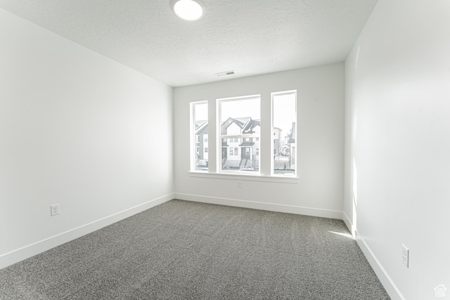 13719 S Devers Dr Unit 2106, Riverton, UT 84096 - empty room featuring carpet floors, a textured ceiling, and baseboards