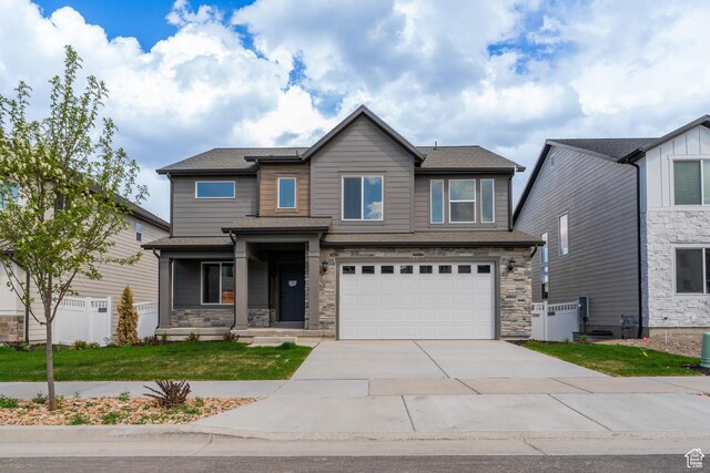 13719 S Devers Dr Unit 2106, Riverton, UT 84096 - view of front facade with concrete driveway, an attached garage, and stone siding