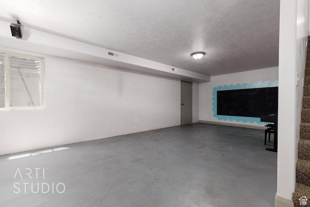 267 N 250 W, La Verkin, UT 84745 - finished below grade area featuring stairs, visible vents, a textured ceiling, and concrete block wall