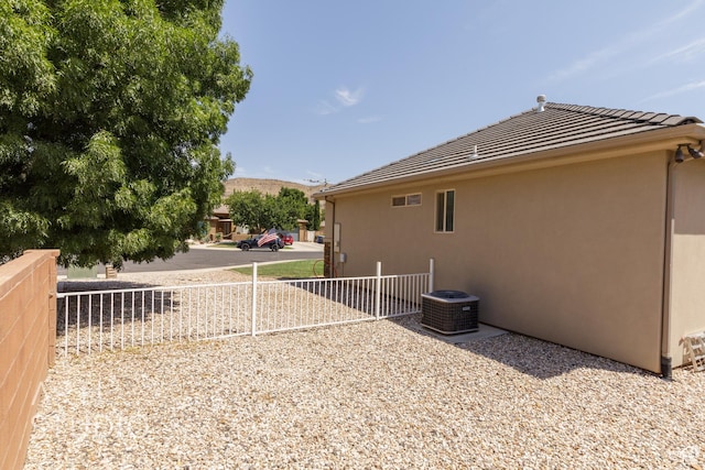 267 N 250 W, La Verkin, UT 84745 - view of side of property featuring stucco siding, central air condition unit, a mountain view, and fence