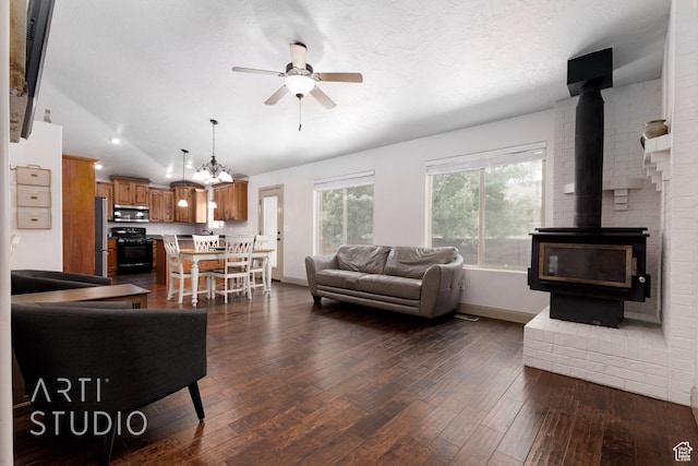 267 N 250 W, La Verkin, UT 84745 - living room with a ceiling fan, a textured ceiling, dark wood-style floors, a wood stove, and vaulted ceiling