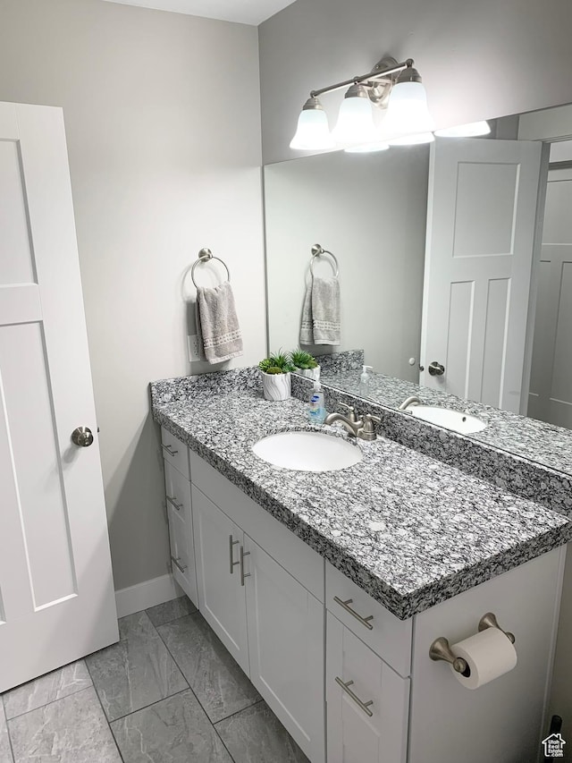 1999 E Abbey Way, Eagle Mountain, UT 84005 - bathroom featuring marble finish floor, vanity, and baseboards