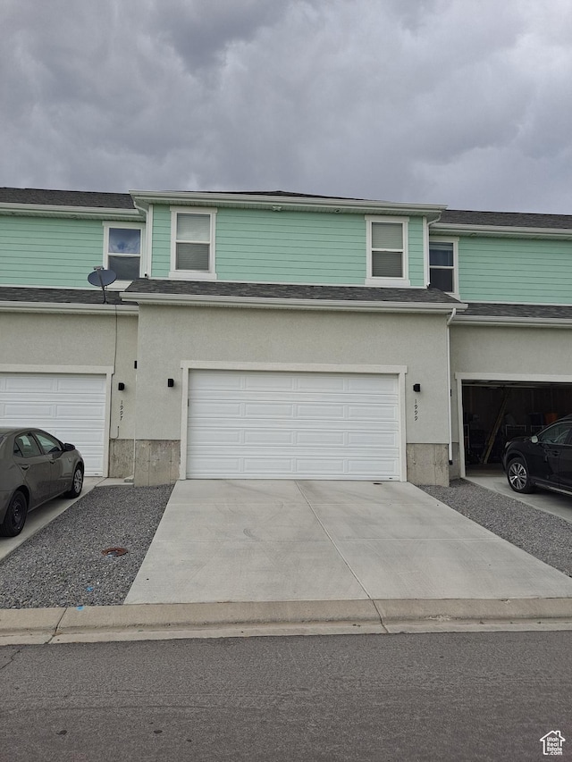 1999 E Abbey Way, Eagle Mountain, UT 84005 - multi unit property featuring a garage, concrete driveway, and stucco siding