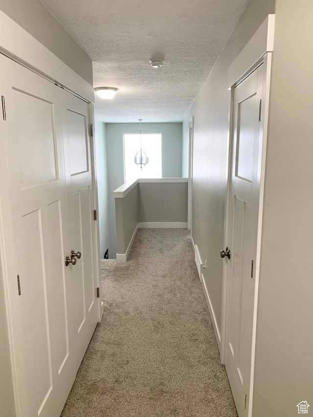 1999 E Abbey Way, Eagle Mountain, UT 84005 - hall with a textured ceiling, carpet flooring, an upstairs landing, and baseboards