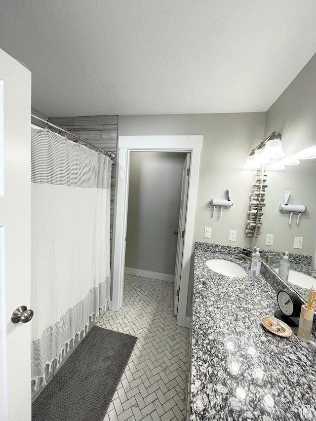 1999 E Abbey Way, Eagle Mountain, UT 84005 - bathroom with curtained shower, baseboards, a textured ceiling, and vanity