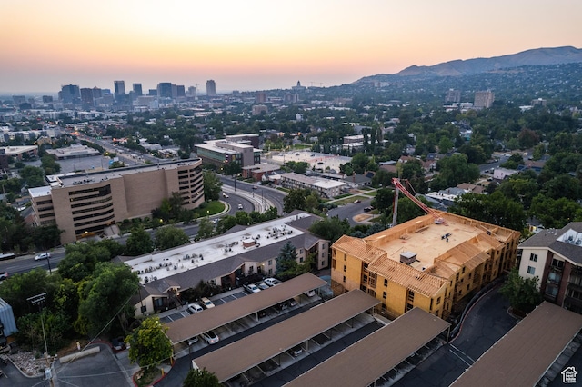 aerial view at dusk featuring a mountain view