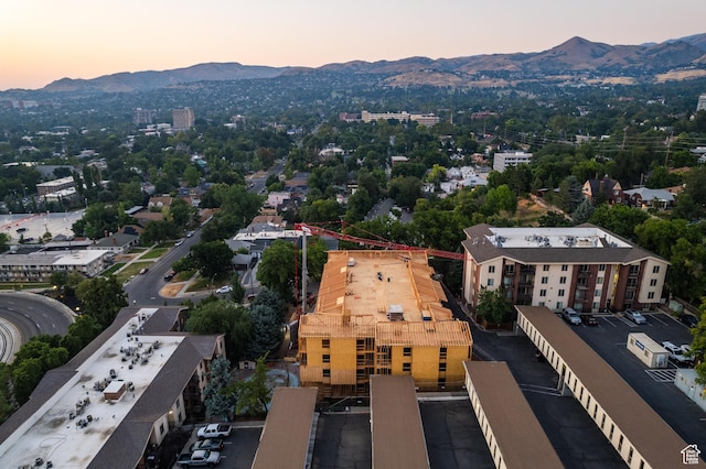 aerial view at dusk featuring a mountain view