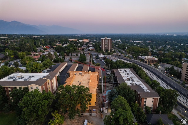 aerial view at dusk featuring a mountain view