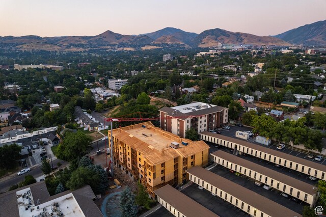 aerial view at dusk featuring a mountain view