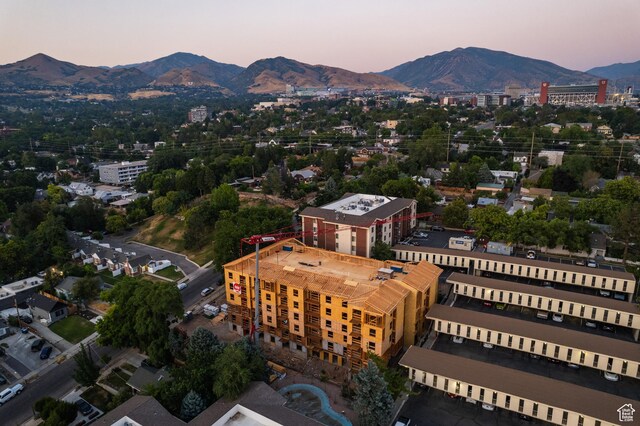 aerial view at dusk featuring a mountain view