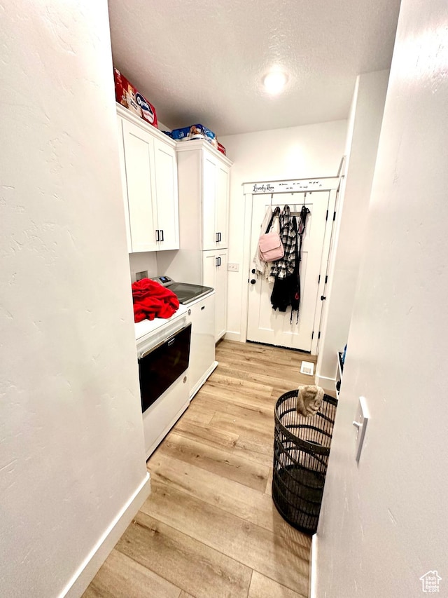 2159 W 520 S, Roosevelt, UT 84066 - washroom with cabinets, washer and dryer, a textured ceiling, and light hardwood / wood-style flooring