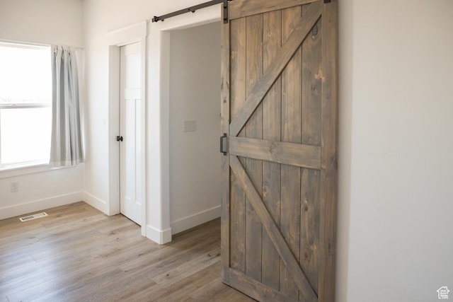2159 W 520 S, Roosevelt, UT 84066 - corridor with a barn door and light wood-style flooring