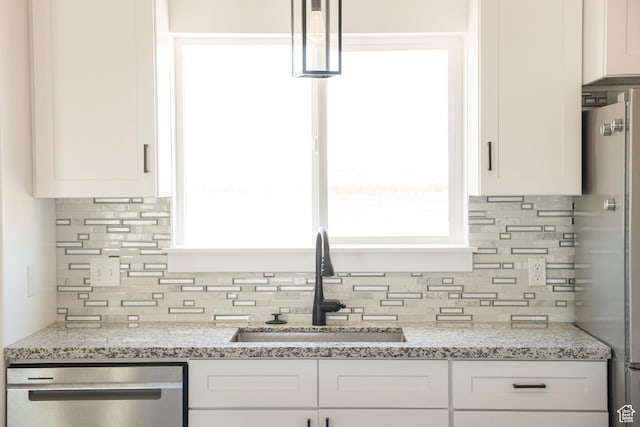 2159 W 520 S, Roosevelt, UT 84066 - kitchen featuring appliances with stainless steel finishes, decorative backsplash, white cabinets, and light stone countertops