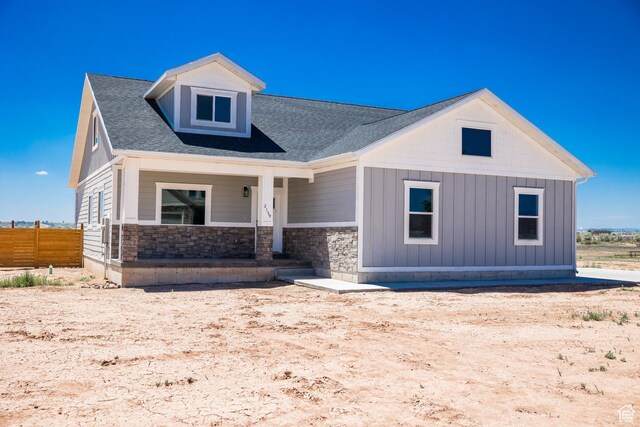 2159 W 520 S, Roosevelt, UT 84066 - view of front of home featuring a porch, stone siding, board and batten siding, and a shingled roof