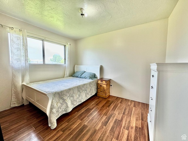 805 E 2910 S, Vernal, UT 84078 - bedroom featuring a textured ceiling and dark wood-style flooring