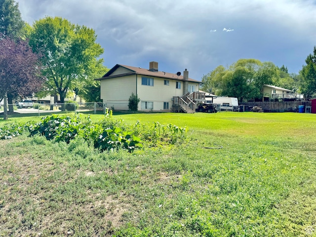 805 E 2910 S, Vernal, UT 84078 - view of yard featuring stairway, a vegetable garden, fence, and a deck