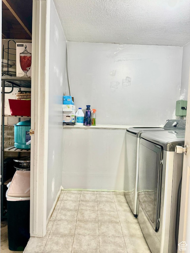 805 E 2910 S, Vernal, UT 84078 - laundry area featuring tile patterned floors, laundry area, a textured ceiling, and washing machine and clothes dryer