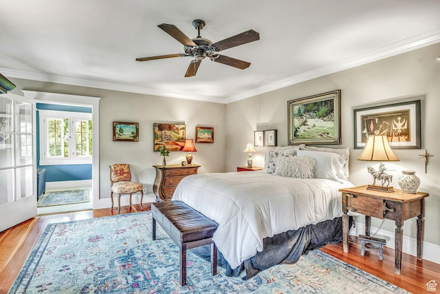 bedroom with crown molding, wood-type flooring, and ceiling fan