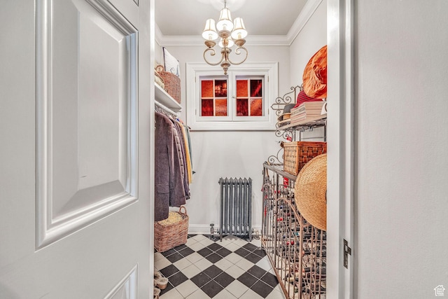 spacious closet with radiator and a notable chandelier