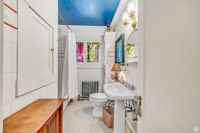 bathroom featuring toilet, sink, a shower with curtain, tile walls, and radiator