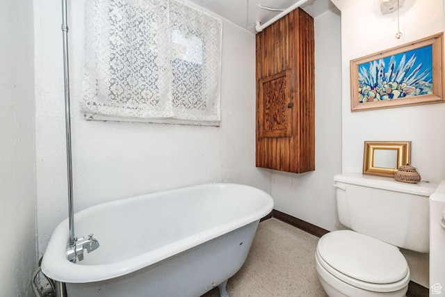 bathroom featuring a bath and toilet