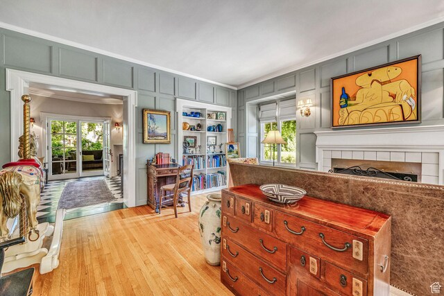 interior space with plenty of natural light, ornamental molding, and light wood-type flooring