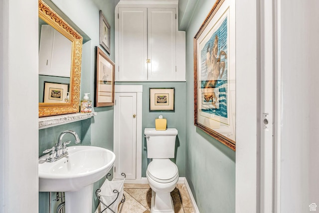 bathroom featuring sink, tile patterned floors, and toilet