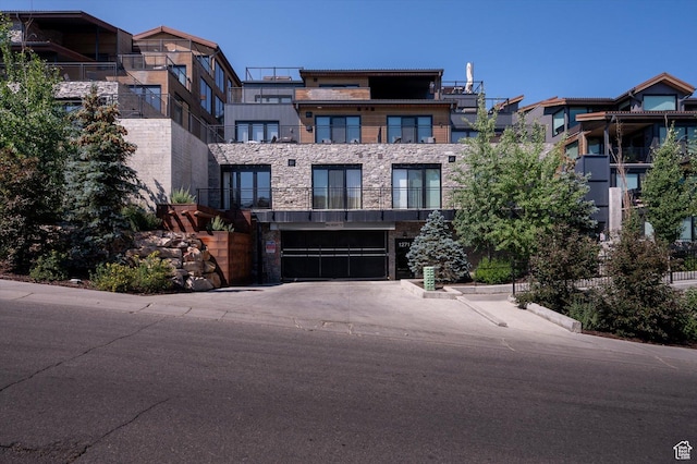 1271 Lowell Ave Unit B-103, Park City, UT 84060 - view of front of home with stone siding, a garage, and aphalt driveway