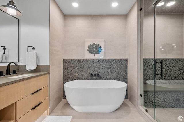 1271 Lowell Ave Unit B-103, Park City, UT 84060 - bathroom with a soaking tub, vanity, tile walls, and a shower stall