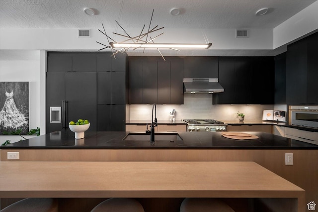 1271 Lowell Ave Unit B-103, Park City, UT 84060 - kitchen featuring stove, under cabinet range hood, a sink, modern cabinets, and wall oven