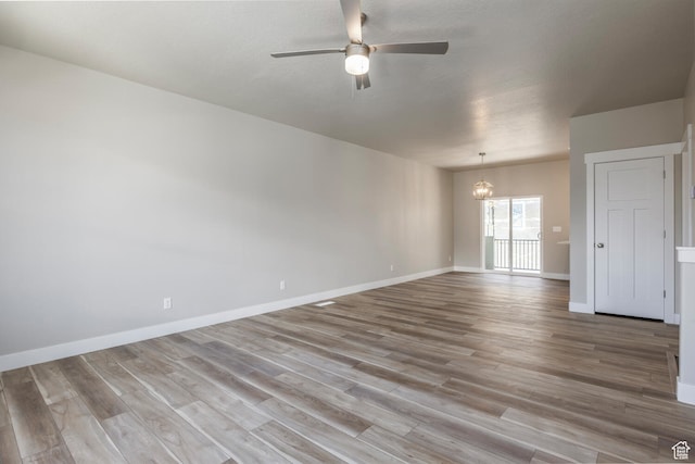 1072 S 2760 E, Spanish Fork, UT 84660 - unfurnished room featuring ceiling fan with notable chandelier and hardwood / wood-style flooring