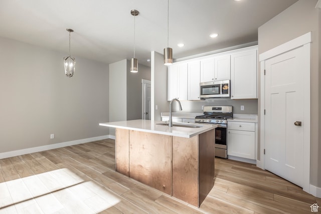 1068 S 2760 E, Spanish Fork, UT 84660 - kitchen with white cabinets, a kitchen island with sink, light hardwood / wood-style floors, appliances with stainless steel finishes, and sink