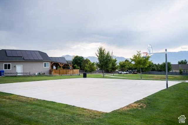 7078 N Sierra Way E, Eagle Mountain, UT 84005 - view of basketball court with a mountain view and a lawn
