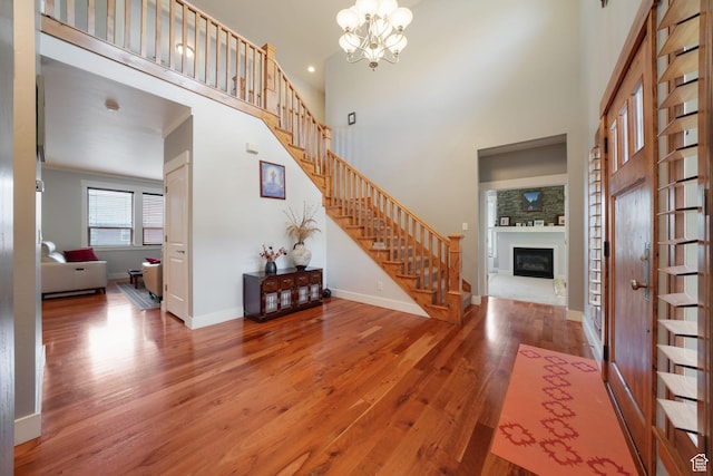 1566 E 300 S, Pleasant Grove, UT 84062 - entrance foyer with a high ceiling, a chandelier, stairway, wood finished floors, and a glass covered fireplace