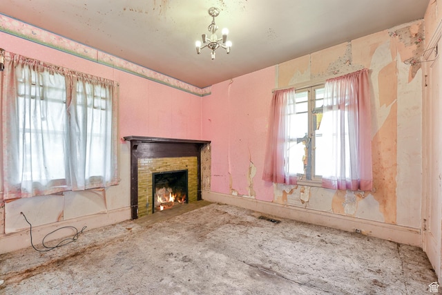 933 W Gentile St, Layton, UT 84041 - unfurnished living room featuring visible vents, a brick fireplace, and an inviting chandelier