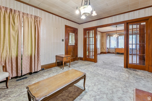 933 W Gentile St, Layton, UT 84041 - carpeted living area with french doors, wallpapered walls, and an inviting chandelier