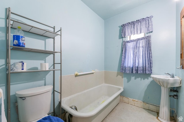 933 W Gentile St, Layton, UT 84041 - full bath featuring tile patterned floors, baseboards, toilet, and a bath