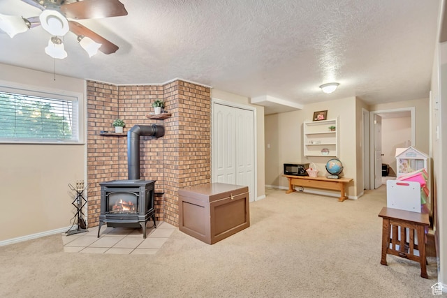 751 W 3500 N, Pleasant View, UT 84414 - carpeted living room with ceiling fan, a wood stove, and a textured ceiling