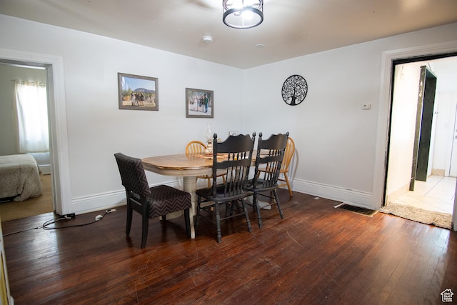 dining space featuring dark wood-type flooring